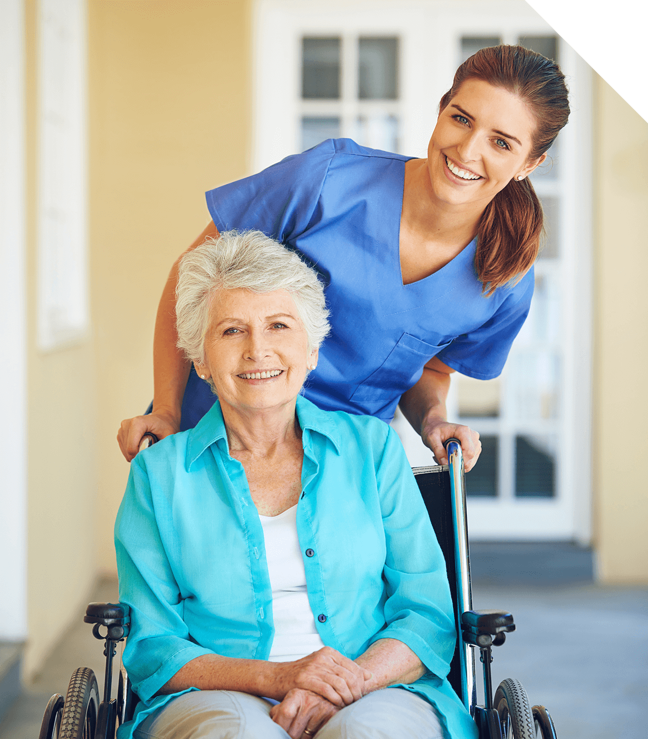 Caregiver assisting elderly woman in wheelchair.